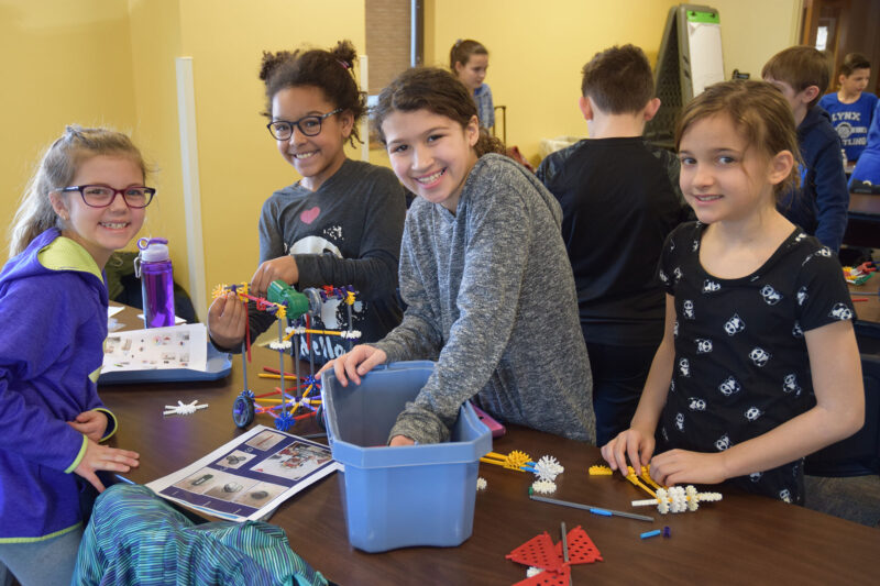 Four middle school age females work with K'Nex during the 2019 STEM Design Challenge