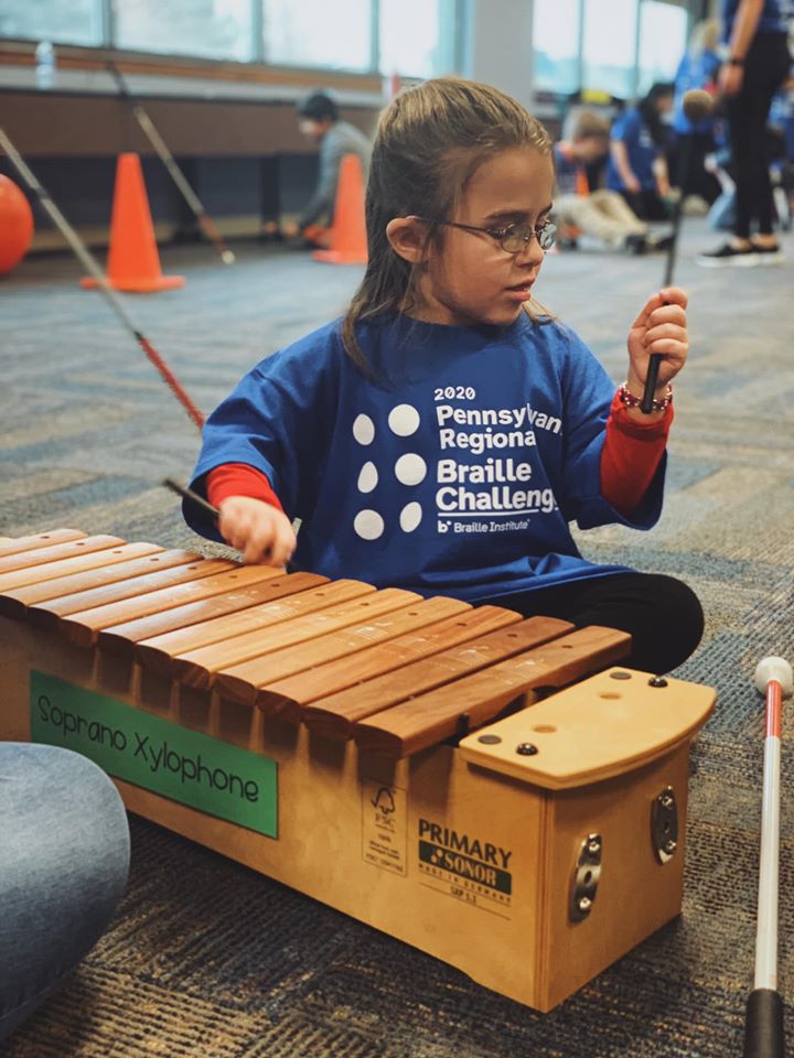 A Braille Challenge participant playing an instrument