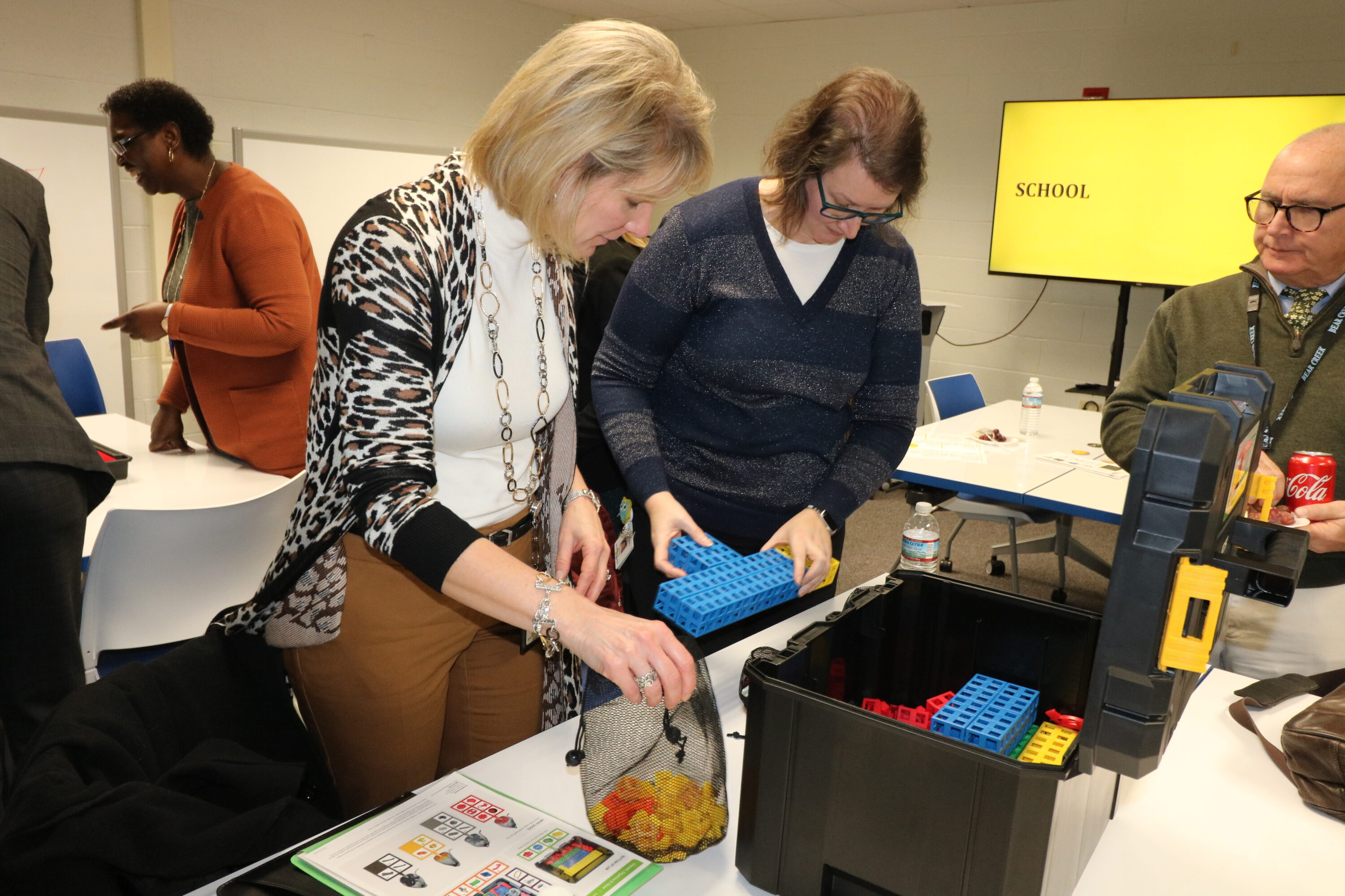 Educators look over a box of STEM supplies at the EPIC launch event.