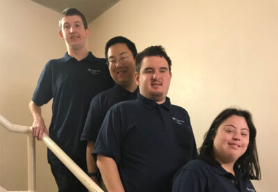 Four students in the Project SEARCH program pose on steps with their Penn State St. Joseph polos.
