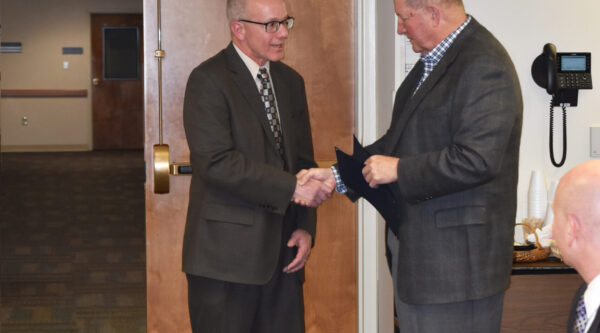 Outgoing Board President Tim Heffner is honored during the January board of directors meeting.