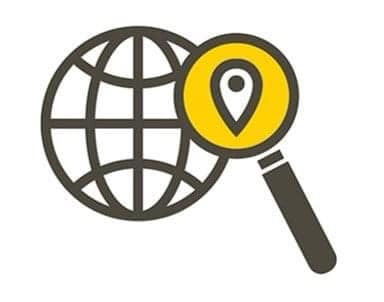Icon of a magnifying glass in front of a globe